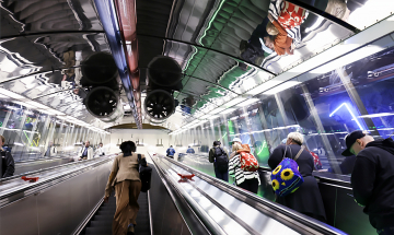 People on a u-tube escalator