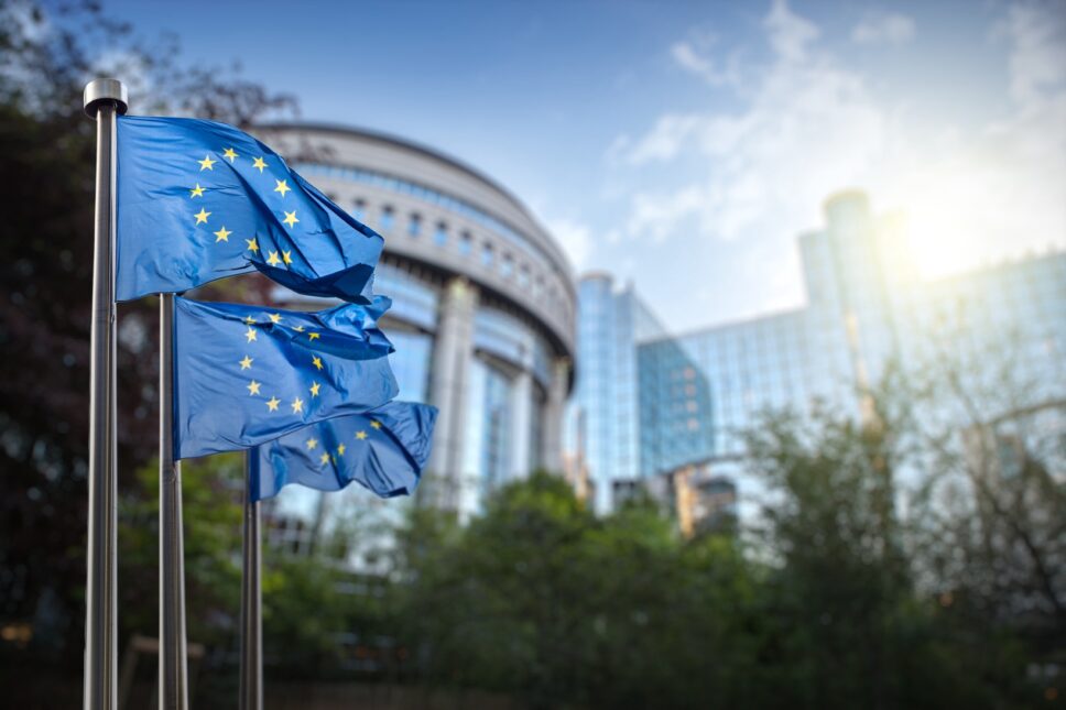 European union flag against parliament in Brussels, Belgium.