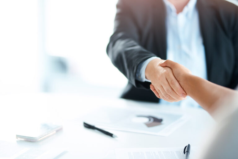 Cropped shot of two businesswomen shaking hands during a meeting in a modern office
